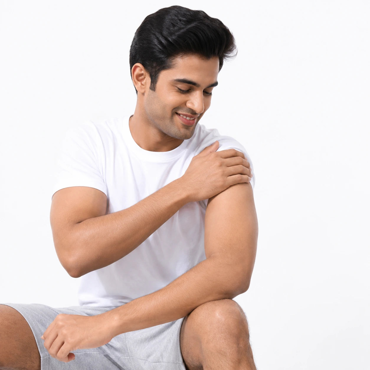 Massaging oil into the shoulder